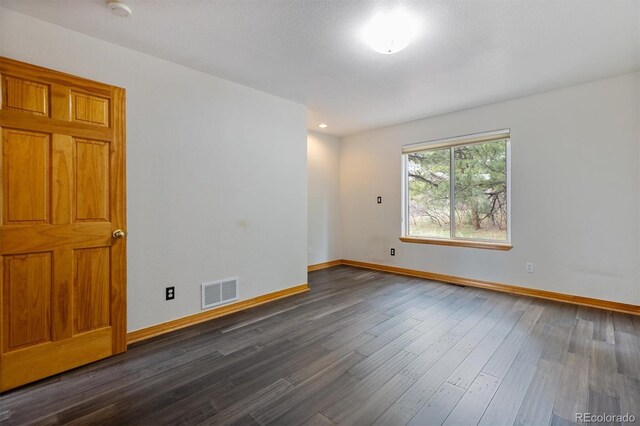7317 Fremont Pl, Larkspur, CO 80118 - unfurnished room featuring dark wood-style floors, baseboards, and visible vents