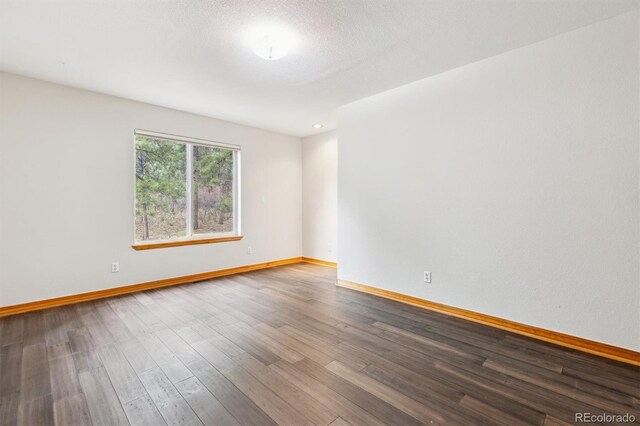 7317 Fremont Pl, Larkspur, CO 80118 - empty room featuring wood finished floors and baseboards