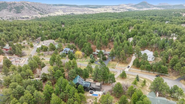 7317 Fremont Pl, Larkspur, CO 80118 - bird's eye view featuring a forest view and a mountain view