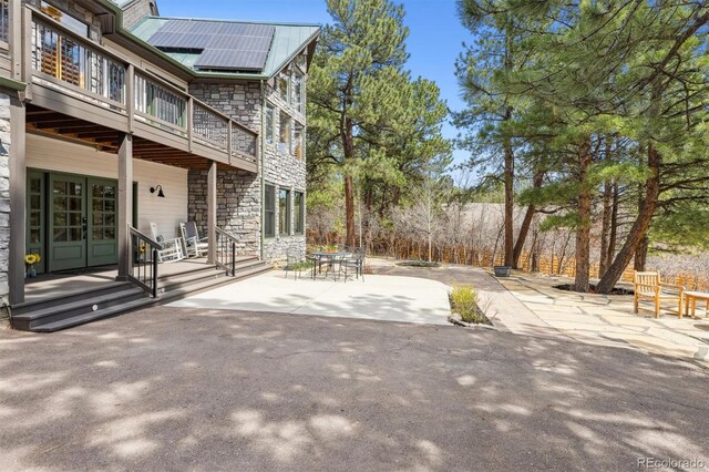 7317 Fremont Pl, Larkspur, CO 80118 - view of patio with outdoor dining space, french doors, and a balcony
