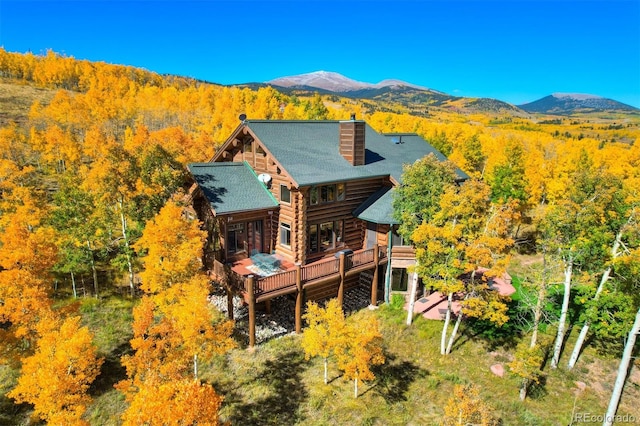 back of property featuring a deck with mountain view