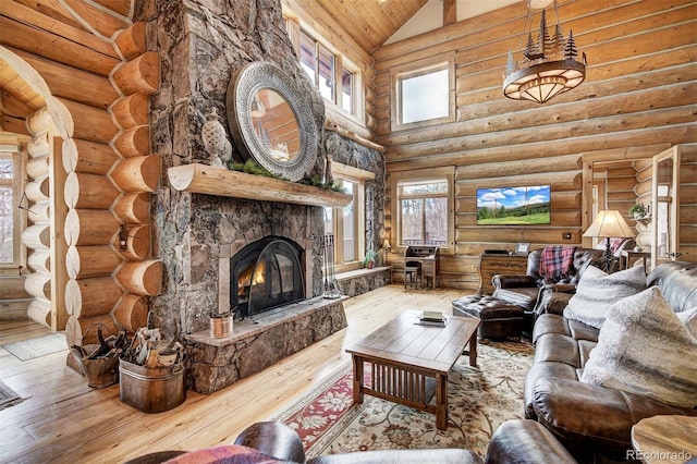 living room with high vaulted ceiling, hardwood / wood-style floors, rustic walls, and a stone fireplace