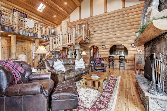 living room featuring rustic walls, wood ceiling, a fireplace, high vaulted ceiling, and hardwood / wood-style flooring