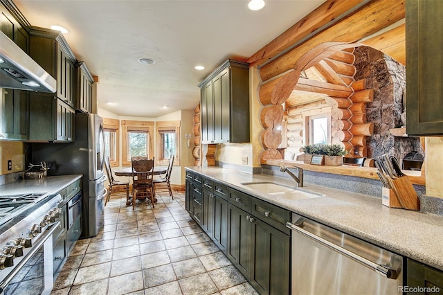 kitchen featuring extractor fan, rustic walls, dark brown cabinets, sink, and appliances with stainless steel finishes