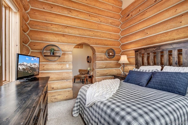 carpeted bedroom with log walls