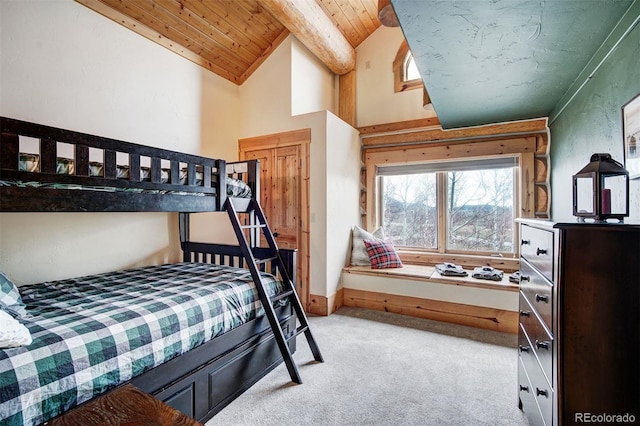 carpeted bedroom with lofted ceiling with beams and wooden ceiling