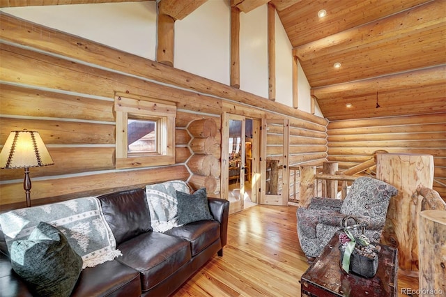 living room with light wood-type flooring, high vaulted ceiling, wood ceiling, and log walls