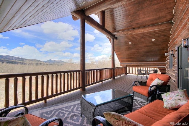 wooden deck featuring an outdoor hangout area and a mountain view