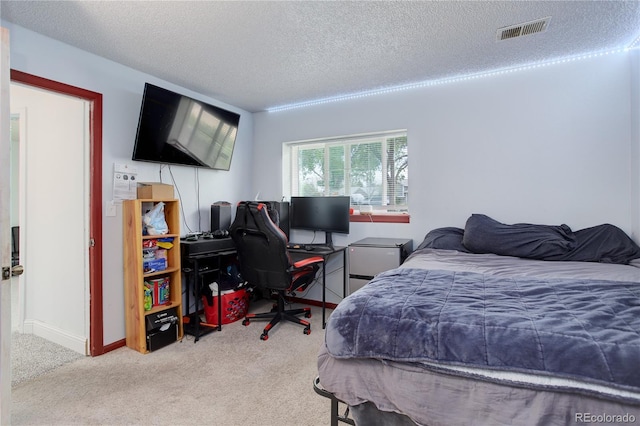 bedroom featuring carpet floors, a desk, a textured ceiling, and baseboards
