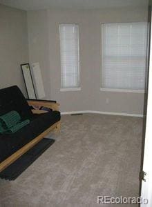 sitting room with baseboards and carpet floors