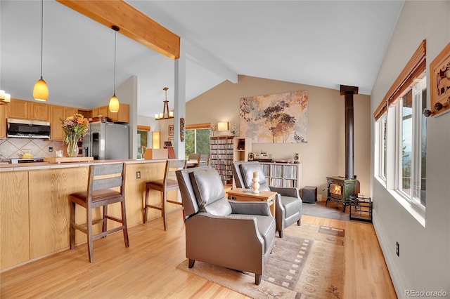 9648 Yegge Rd, Morrison, CO 80465 - living room with light wood finished floors and a wood stove