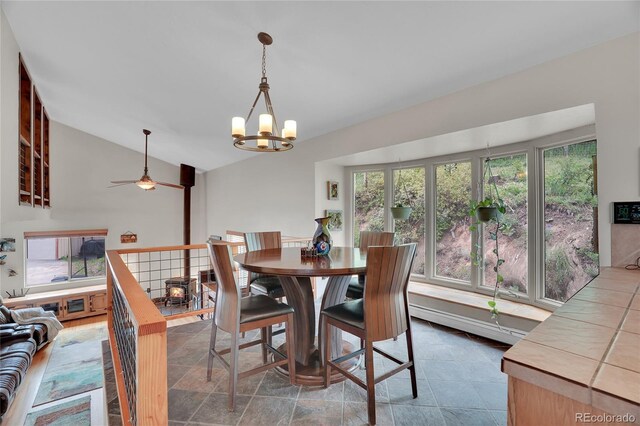 9648 Yegge Rd, Morrison, CO 80465 - dining space with lofted ceiling, ceiling fan, and a chandelier