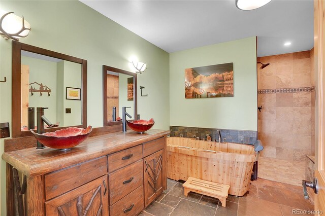 9648 Yegge Rd, Morrison, CO 80465 - bathroom featuring a garden tub, double vanity, a tile shower, and recessed lighting