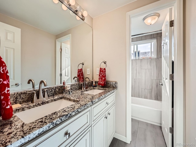 bathroom featuring vanity and tiled shower / bath combo