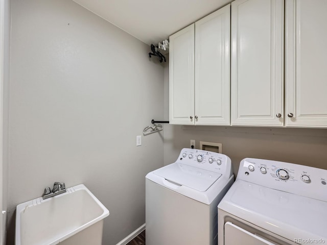 clothes washing area featuring cabinets, independent washer and dryer, and sink