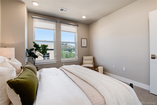 carpeted bedroom with recessed lighting, visible vents, and baseboards