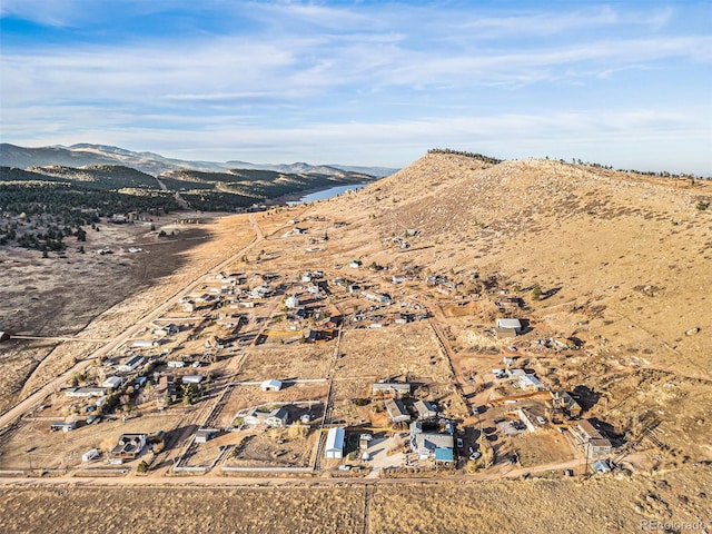 birds eye view of property with a mountain view