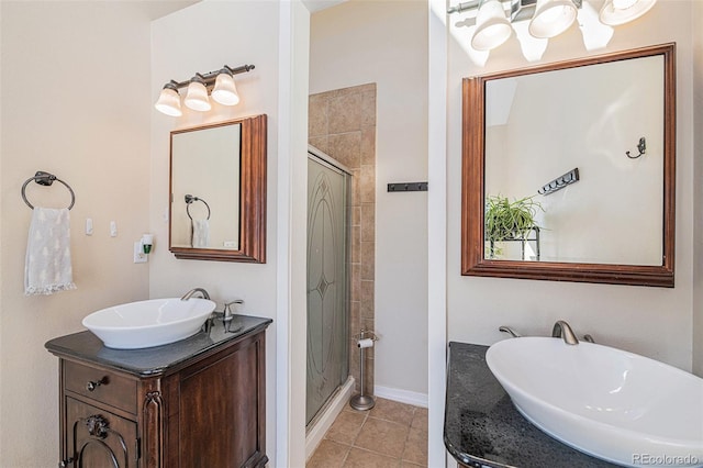 full bathroom featuring a stall shower, vanity, an inviting chandelier, and tile patterned floors