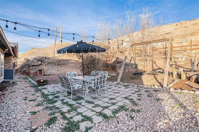 view of yard with an outdoor fire pit, fence, and a patio