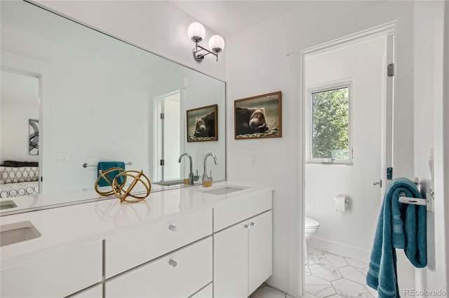 bathroom featuring vanity and toilet