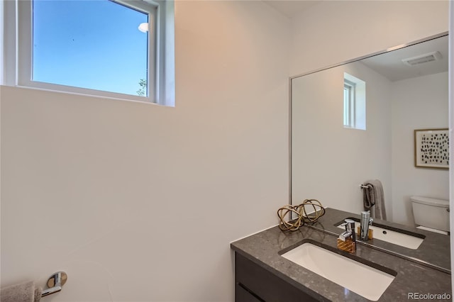 bathroom featuring vanity and toilet