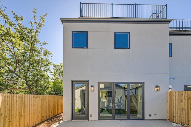 rear view of property with a balcony