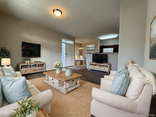 living room with wood-type flooring and a chandelier