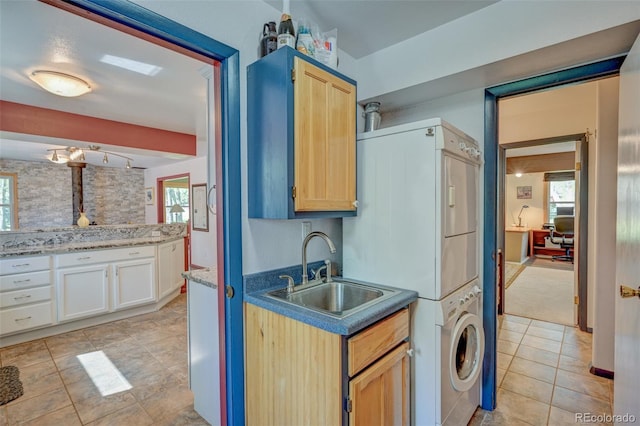 29250 County Road 330, Buena Vista, CO 81211 - kitchen with stacked washer / dryer, light tile patterned floors, light brown cabinets, and track lighting