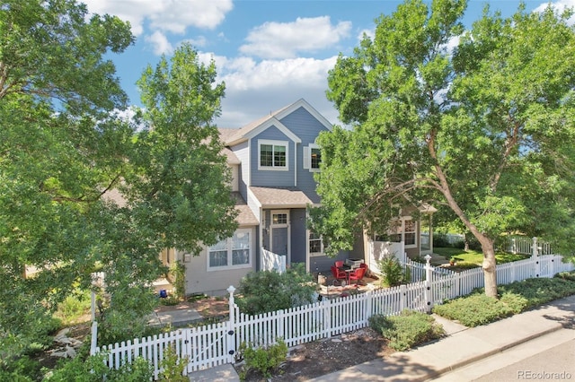588 Beauprez Ave, Lafayette, CO 80026 - view of property hidden behind natural elements featuring a fenced front yard and a shingled roof