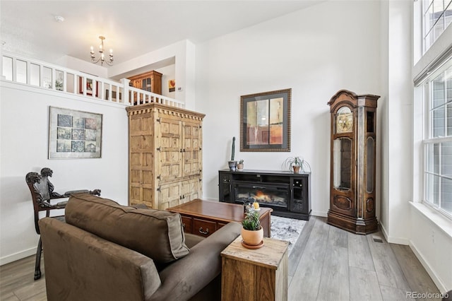 588 Beauprez Ave, Lafayette, CO 80026 - living room featuring a chandelier, wood finished floors, and a glass covered fireplace