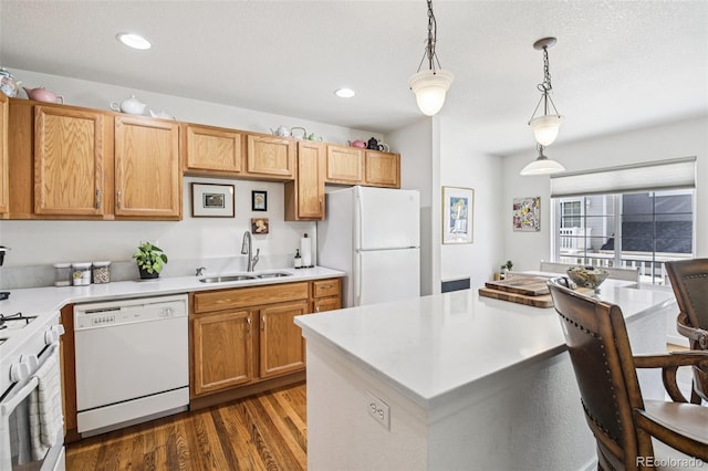 588 Beauprez Ave, Lafayette, CO 80026 - kitchen with white appliances, dark wood-style flooring, light countertops, hanging light fixtures, and recessed lighting