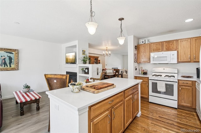 588 Beauprez Ave, Lafayette, CO 80026 - kitchen featuring white appliances, light wood-style floors, a chandelier, light countertops, and recessed lighting