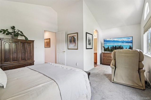 588 Beauprez Ave, Lafayette, CO 80026 - bedroom with light colored carpet, arched walkways, and high vaulted ceiling