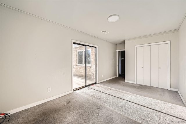 unfurnished bedroom featuring carpet floors, access to outside, and a closet