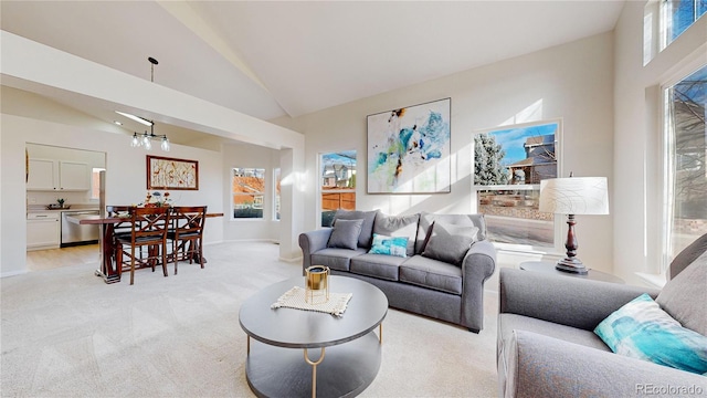 living room featuring light carpet, vaulted ceiling, and a notable chandelier