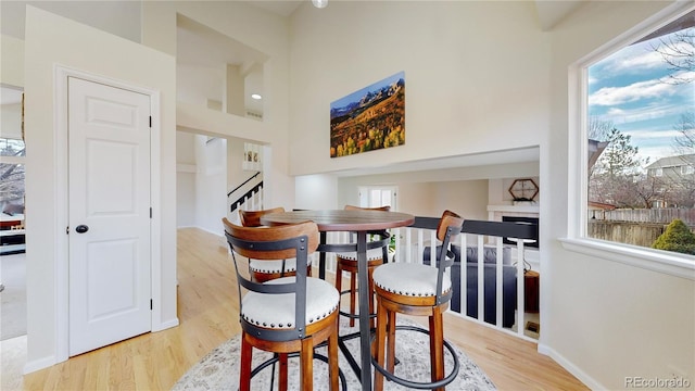 dining area with light hardwood / wood-style floors and a wealth of natural light