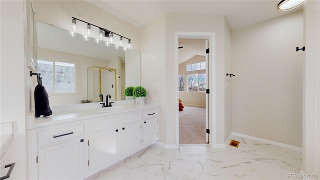 bathroom featuring vanity and a shower with door