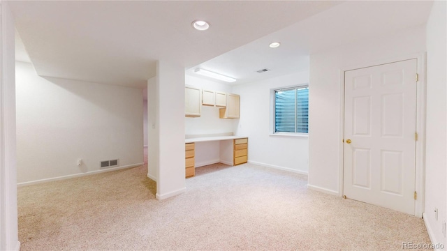 kitchen featuring light carpet and light brown cabinetry