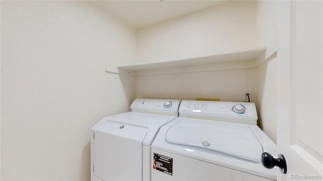 washroom with washing machine and clothes dryer