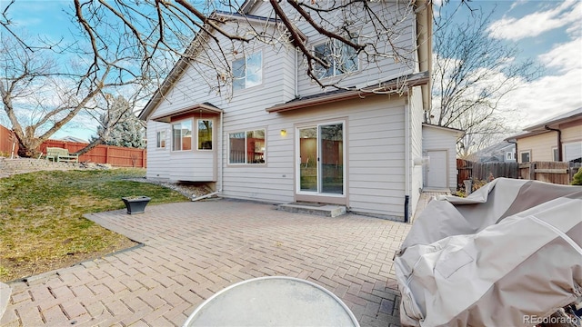 rear view of house with a patio area and a yard