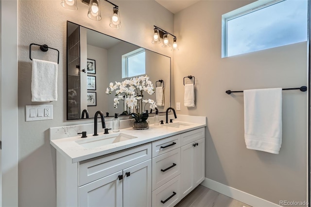 full bathroom featuring a sink and double vanity