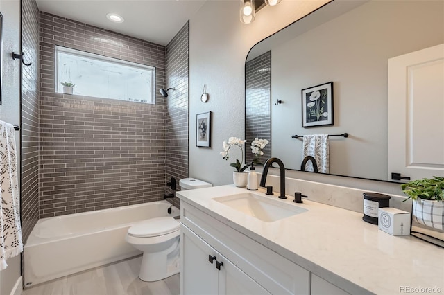 bathroom featuring shower / bath combination, vanity, and toilet