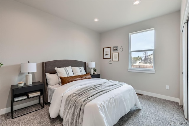 carpeted bedroom featuring baseboards and recessed lighting