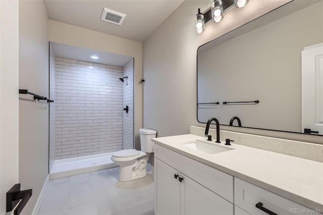 bathroom with vanity, a stall shower, toilet, and visible vents