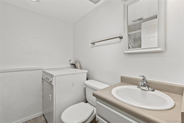 bathroom featuring toilet, wood finished floors, visible vents, vanity, and walk in shower