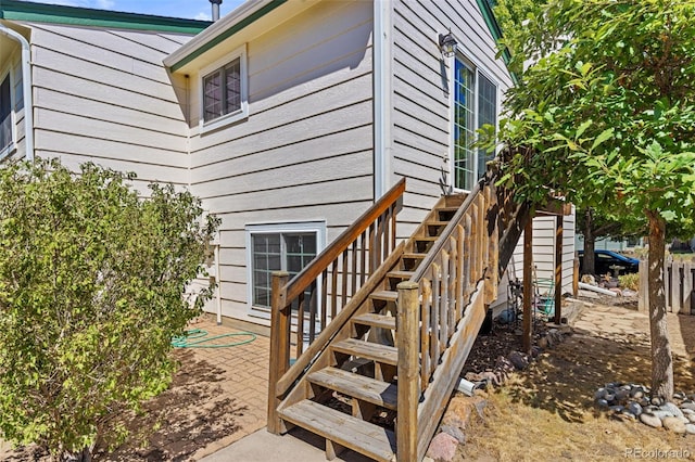 view of exterior entry with a patio area