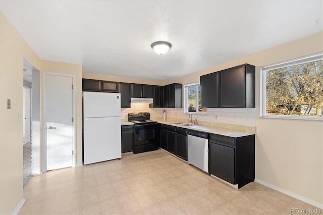 kitchen with stainless steel dishwasher, white fridge, decorative backsplash, black electric range, and sink