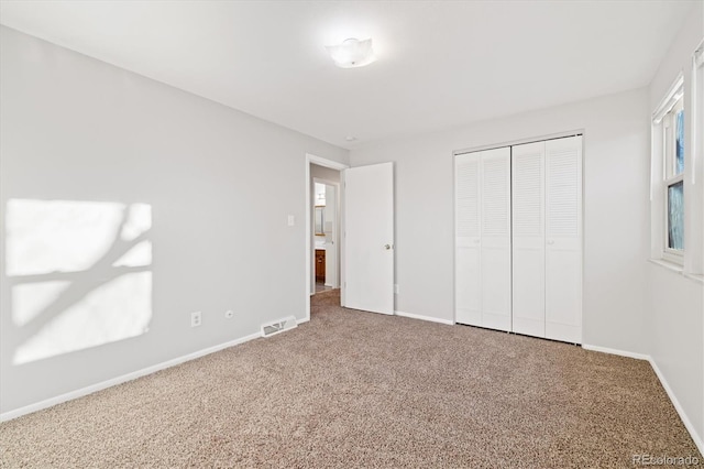 unfurnished bedroom featuring a closet and carpet