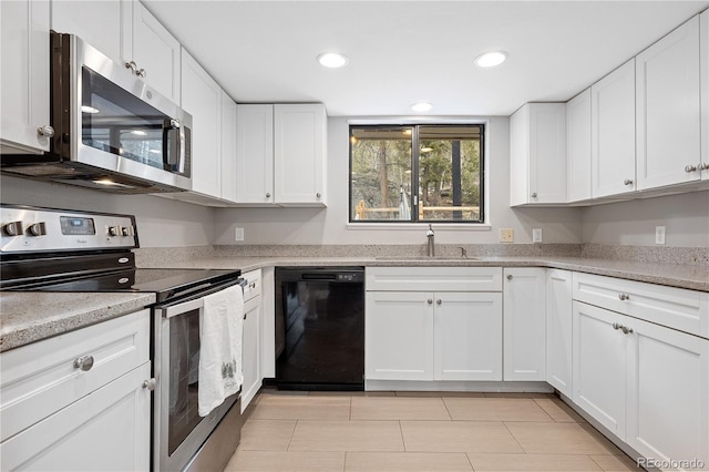 kitchen featuring a sink, stainless steel appliances, white cabinets, and recessed lighting