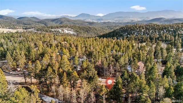 property view of mountains featuring a forest view